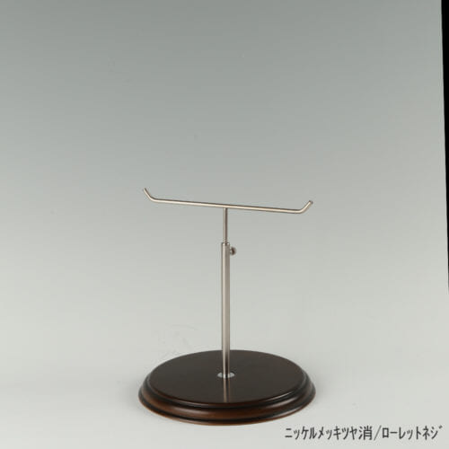 ●商品名:アクセサリースタンド-S ローレットネジ・木製ベース仕様 ●表面処理:金具部 ニッケルツヤ消(NI-M)/木部 茶染め ●寸法:高さ225~315mm ●ヘッド部:T字型 ●ヘッド:上下可動式(伸縮式) ●材質:スチール・木製(ベース) ●特長:特長:シンプルで汎用性のある金具部分に、木製ベースを組み合わせ、落ち着きのある存在感と高級感を演出できるツールとし製造しております。 ●生産国:日本(タヤ自社工場)